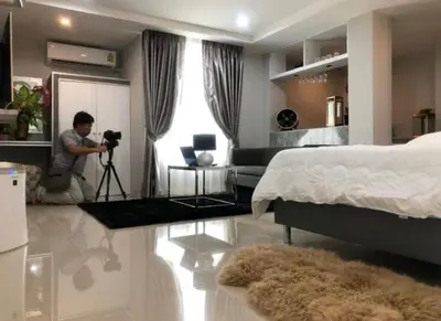 a man taking a picture of a bedroom with a camera at 51 Suanplu Residence in Bangkok
