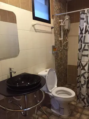 a bathroom with a toilet and a sink at Angie Resort at Sapan Mai in Bangkok