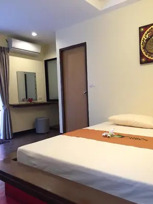 a hotel room with a bed with a door and a room at Angie Resort at Sapan Mai in Bangkok