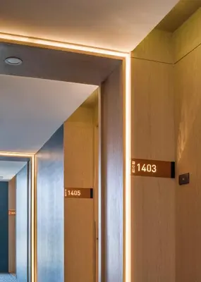 a bathroom with wooden doors with numbers on them at Zayn Hotel Bangkok - Airport Link Access in Bangkok