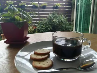 a plate with cookies and a cup of coffee on a table at U431 Chaengwattana in Nonthaburi