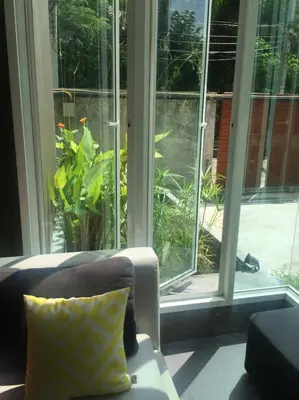 a living room with a couch and a window at U431 Chaengwattana in Nonthaburi