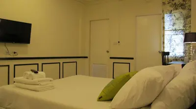 a bedroom with a white bed with towels on it at U431 Chaengwattana in Nonthaburi