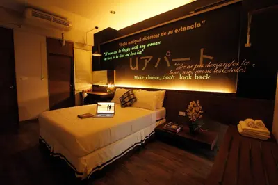 a hotel room with a bed with a sign on the wall at U431 Chaengwattana in Nonthaburi