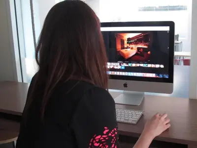 a woman sitting at a desk with a computer monitor at U431 Chaengwattana in Nonthaburi