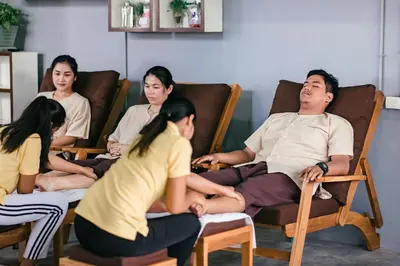 a group of people sitting in chairs in a room at Grand Howard Hotel Bangkok in Bangkok