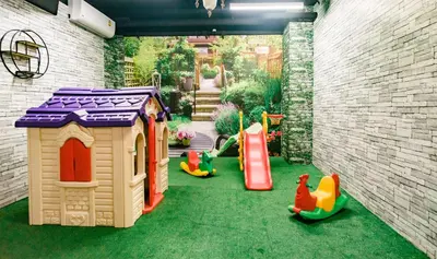 a backyard with a play area with toys on the grass at Grand Howard Hotel Bangkok in Bangkok