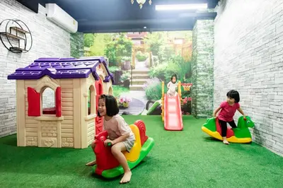 a group of children playing in a play room at Grand Howard Hotel Bangkok in Bangkok
