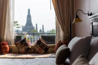 a bedroom with a window with a view of the eiffel tower at Sala Arun in Bangkok