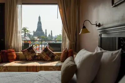 a hotel room with a bed and a window with a view at Sala Arun in Bangkok