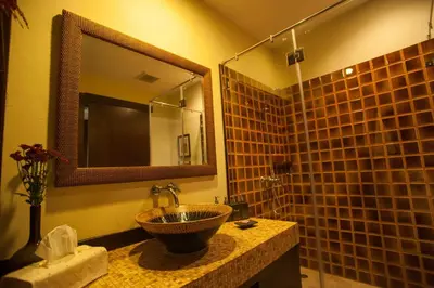a bathroom with a sink and a mirror at Sala Arun in Bangkok