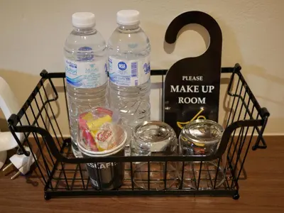 a basket with two bottles of water and other items at Let's Zzz Bangkok in Bangkok