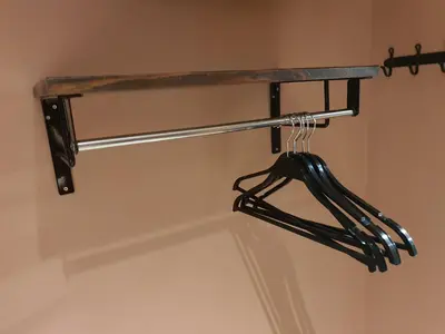 a black umbrella hanging from a shelf in a bathroom at Let's Zzz Bangkok in Bangkok