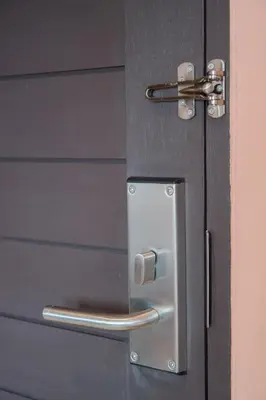 a door with a metal door handle on it at Let's Zzz Bangkok in Bangkok