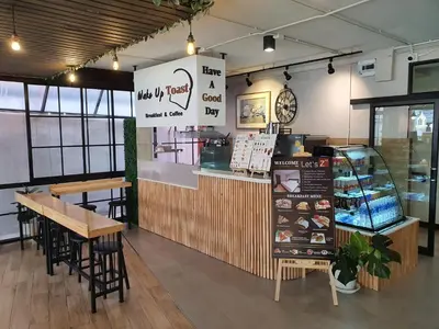 a restaurant with a counter and a table and chairs at Let's Zzz Bangkok in Bangkok