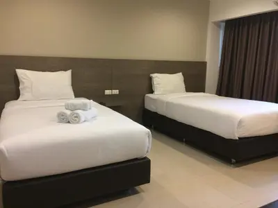 a hotel room with two beds with towels on them at 14 Resort in Bangkok