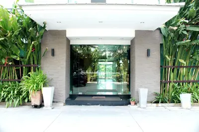 a front door of a building with plants at 14 Resort in Bangkok