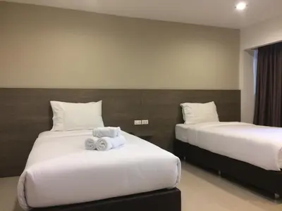a hotel room with two beds with towels on them at 14 Resort in Bangkok