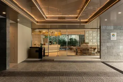a lobby with glass doors and a dining area at Hyatt Place Bangkok Sukhumvit 1 in Bangkok
