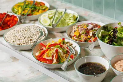a table topped with bowls of different types of food at Hyatt Place Bangkok Sukhumvit 1 in Bangkok