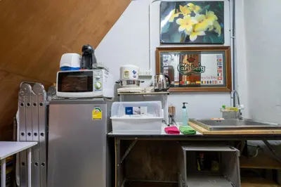 a kitchen with a refrigerator and a sink at Sip N' Camp in Bangkok