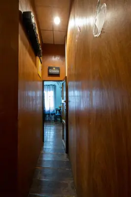 a hallway in an office with a door and a table at Sip N' Camp in Bangkok