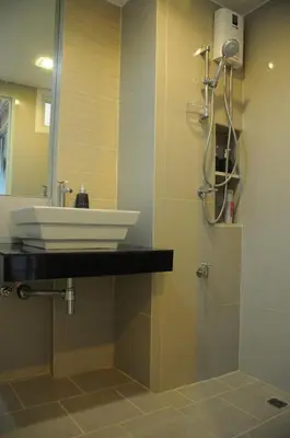 a bathroom with a sink and a shower at Delight Residence in Bangkok