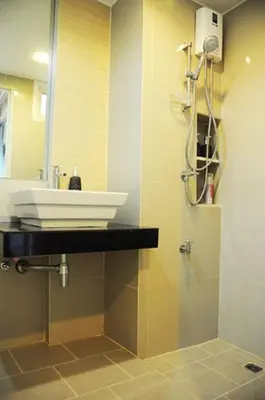 a bathroom with a white sink and a shower at Delight Residence in Bangkok