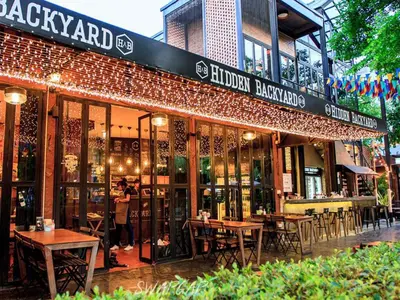 a restaurant with tables and chairs outside of a building at Botanic Service Room at Impact Muangthongthani - SHA Certified in Nonthaburi
