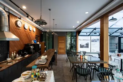 a restaurant with tables and chairs in a room at Botanic Service Room at Impact Muangthongthani - SHA Certified in Nonthaburi