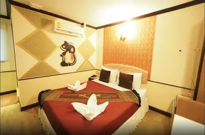 a bedroom with a bed with two white butterflies on it at Honey House1 hotel in Bangkok