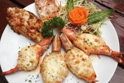 a plate of food with shrimp and a salad at Honey House1 hotel in Bangkok