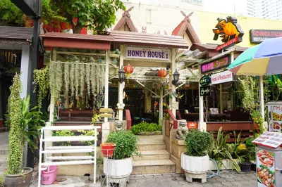 a front of a store with plants in front of it at Honey House1 hotel in Bangkok