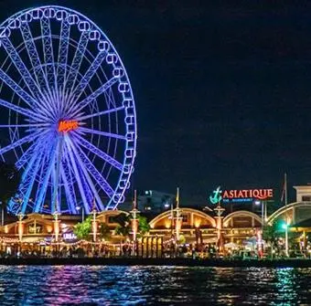a ferris wheel is lit up at night at Honey House1 hotel in Bangkok