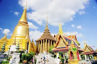 a group of buildings with pagodas and people standing outside at Honey House1 hotel in Bangkok