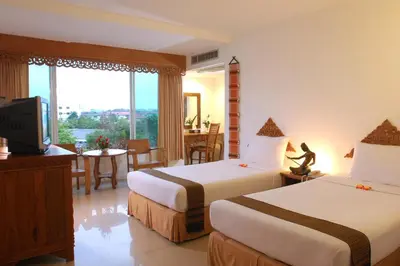 a hotel room with two beds and a television at Bansabai Hostelling International in Bangkok