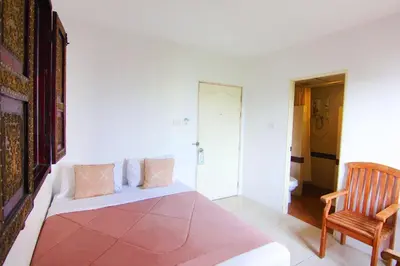 a living room with a couch and a chair at Bansabai Hostelling International in Bangkok