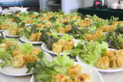 a bunch of plates of food on a table at Bansabai Hostelling International in Bangkok