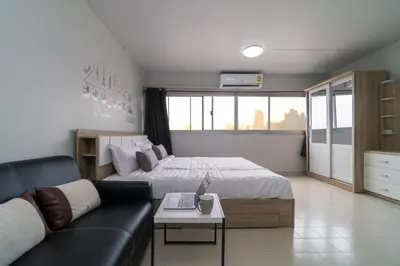 a living room with a bed and a couch at Popular Condo Muangthong by Khun Eve in Nonthaburi