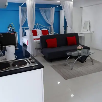 a living room with a couch and a bed at SLT Apartment Bangkok in Bangkok