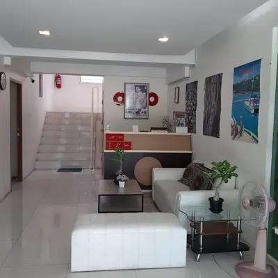 a living room with a couch and a table at SLT Apartment Bangkok in Bangkok