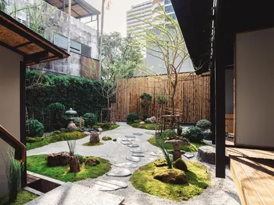 a garden with rocks and trees in a building at MAYU Bangkok Japanese Style Hotel in Bangkok