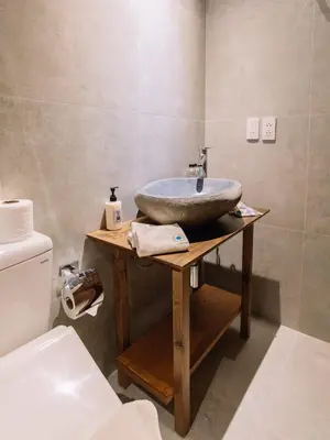 a bathroom with a sink on a wooden table at MAYU Bangkok Japanese Style Hotel in Bangkok