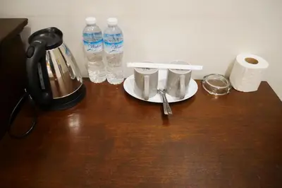 a table with a plate and a bottle of water at The 92 Residence in Bangkok