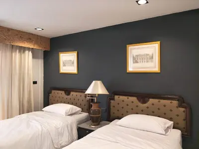 a bedroom with two beds and a blue wall at The 92 Residence in Bangkok