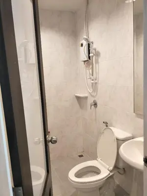 a bathroom with a shower with a toilet and a sink at The 92 Residence in Bangkok