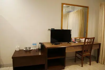 a desk with a computer monitor on top of it at The 92 Residence in Bangkok