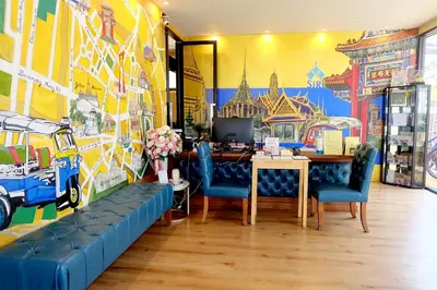 a dining room with a table and blue chairs at Siri Oriental Bangkok Hotel in Bangkok