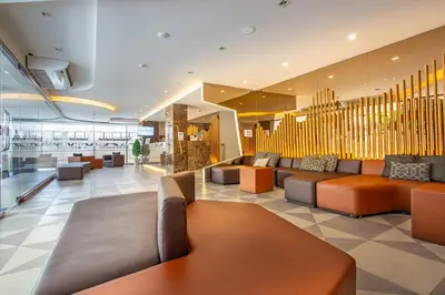 a lobby with couches and tables in a building at Spittze Hotel Pratunam in Bangkok