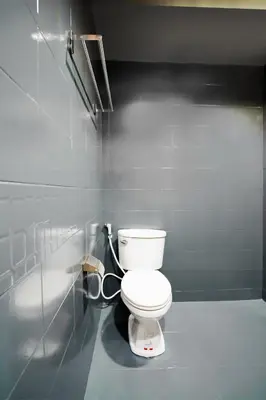 a bathroom with a white toilet in a room at Matini Ratchada 32 in Bangkok